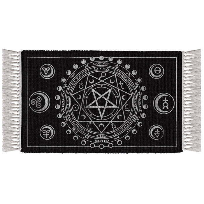 Black rug with white fringe featuring central pentagram design and various symbols on a white background